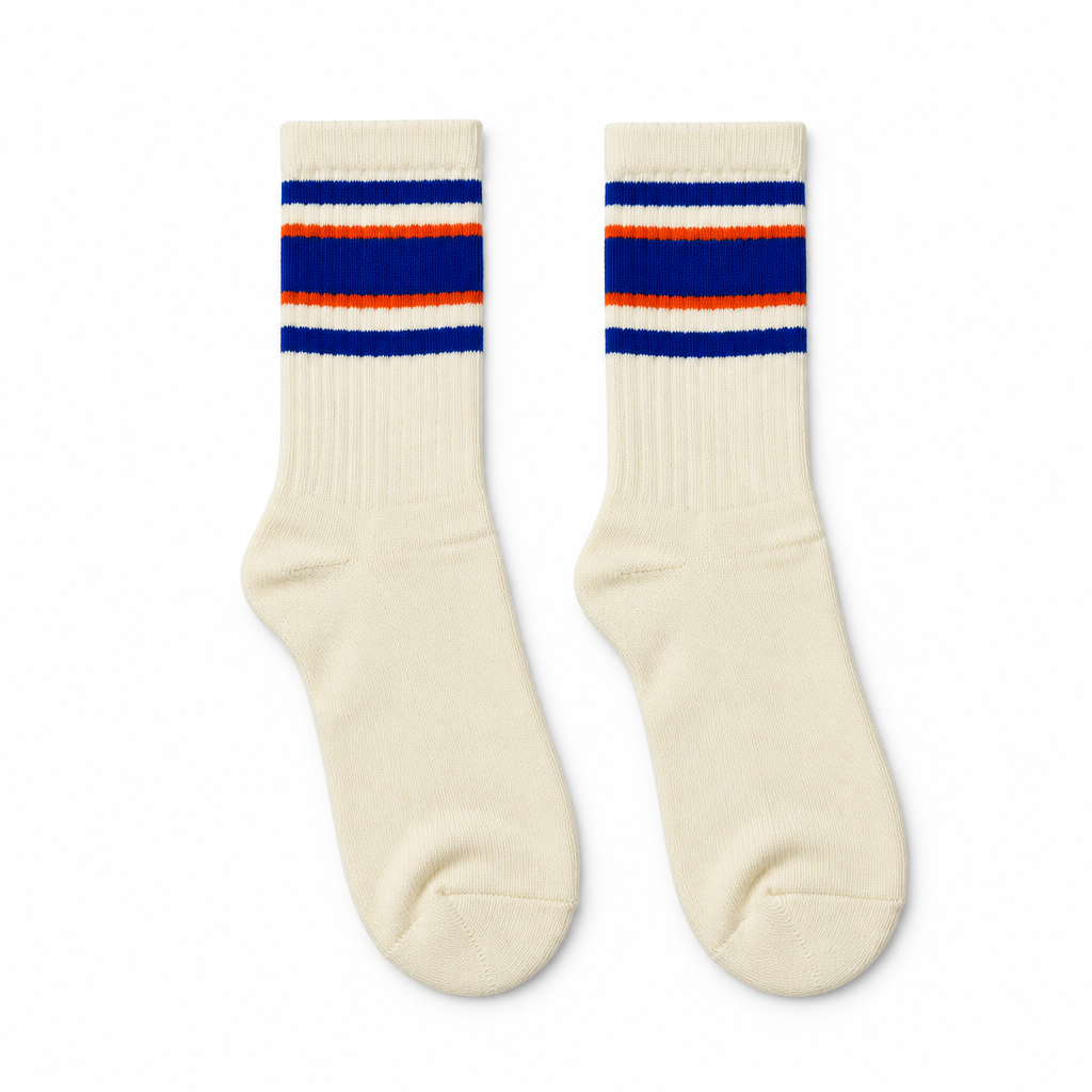Cream socks with blue and orange stripes laid flat on seamless white