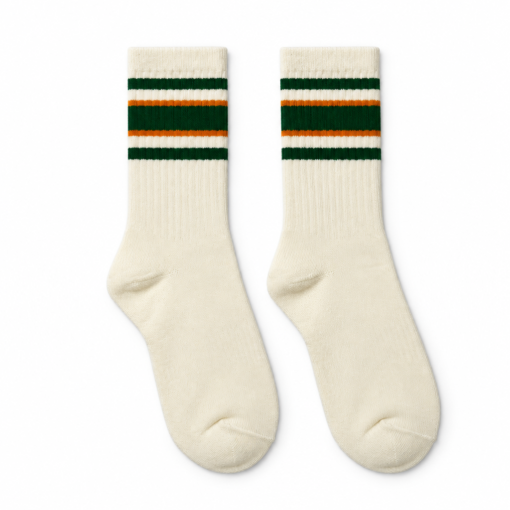 Cream socks with green and orange stripes laid flat on seamless white