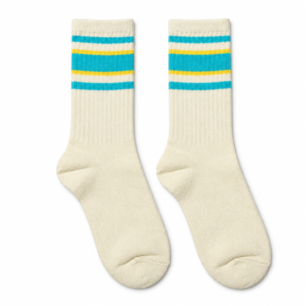 Cream socks with turquoise and yellow stripes laid flat on white