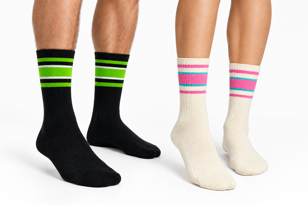 Male and female lower-leg close-up wearing two sock colorways together in a white studio